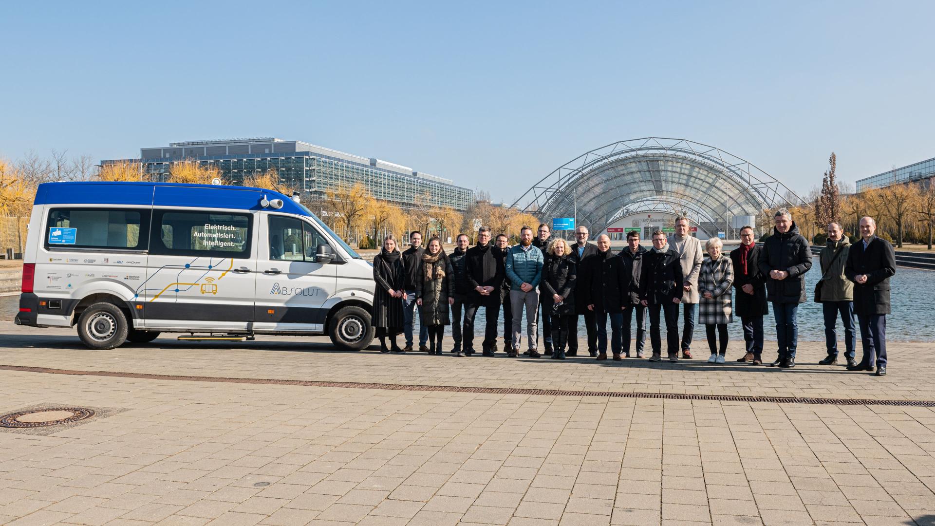 A group of people stand outside next to a van