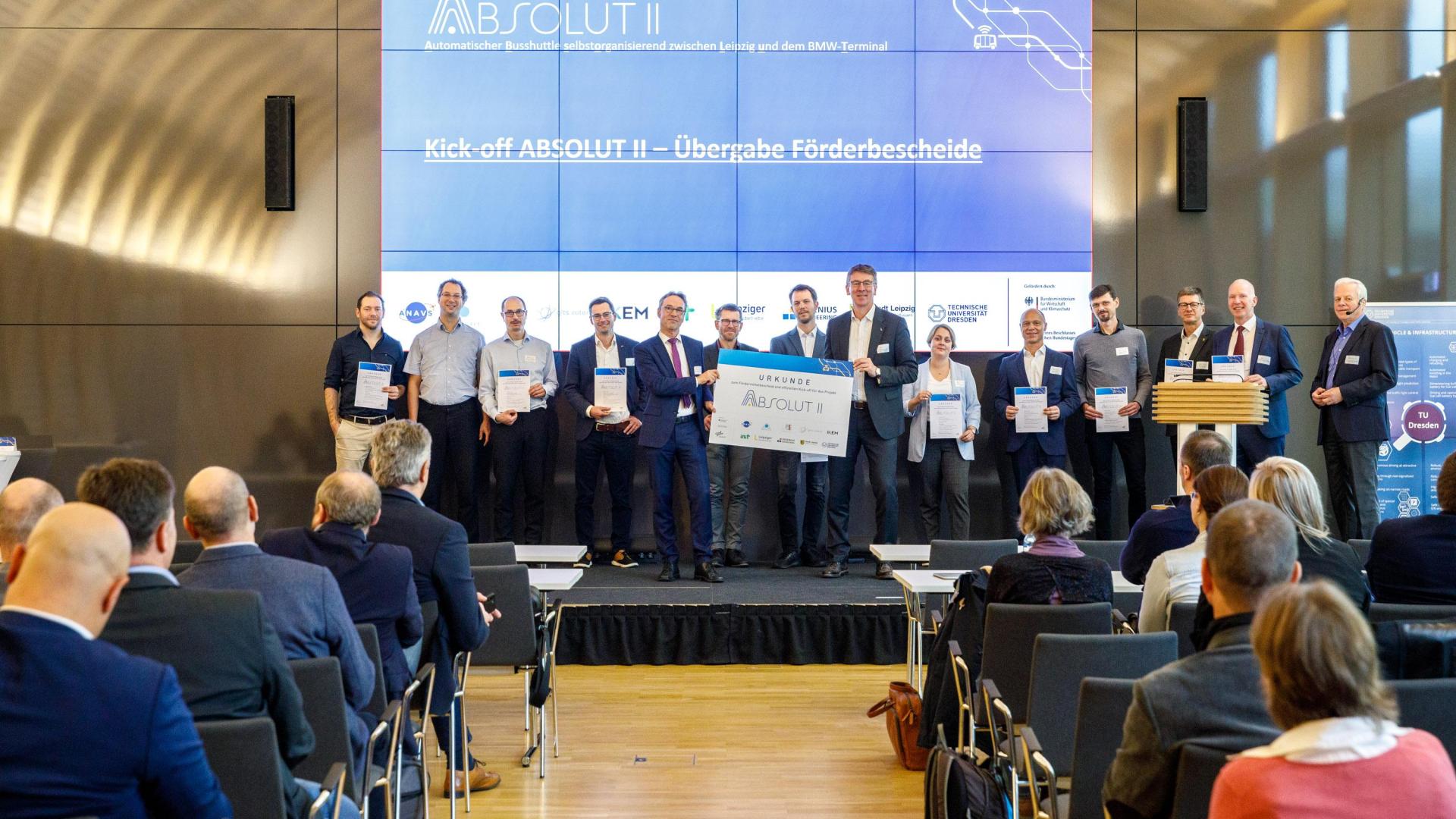 Group photo of all representatives of the ABSOLUT II project holding a funding certificate