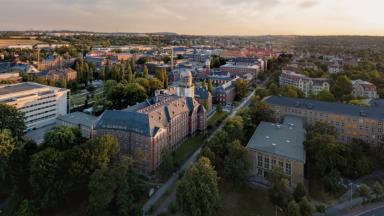 Collage: View from above over the TUD campus and a portrait of a man with a beard and glasses