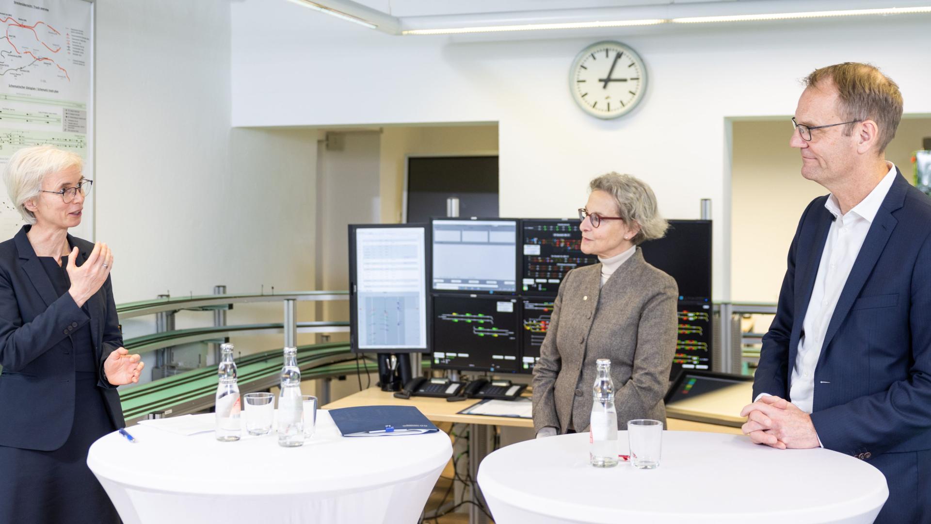 Two women and a man standing in a laboratory