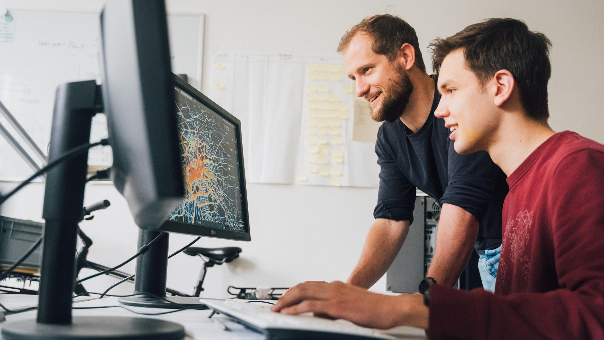 Two men looking at a computer screen