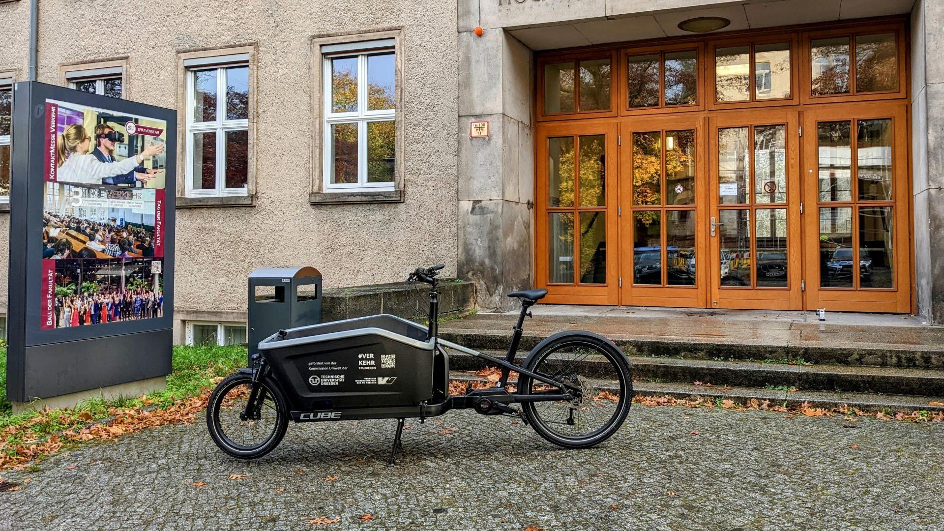 An e-bike parked in front of a university building