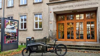 An e-bike parked in front of a university building