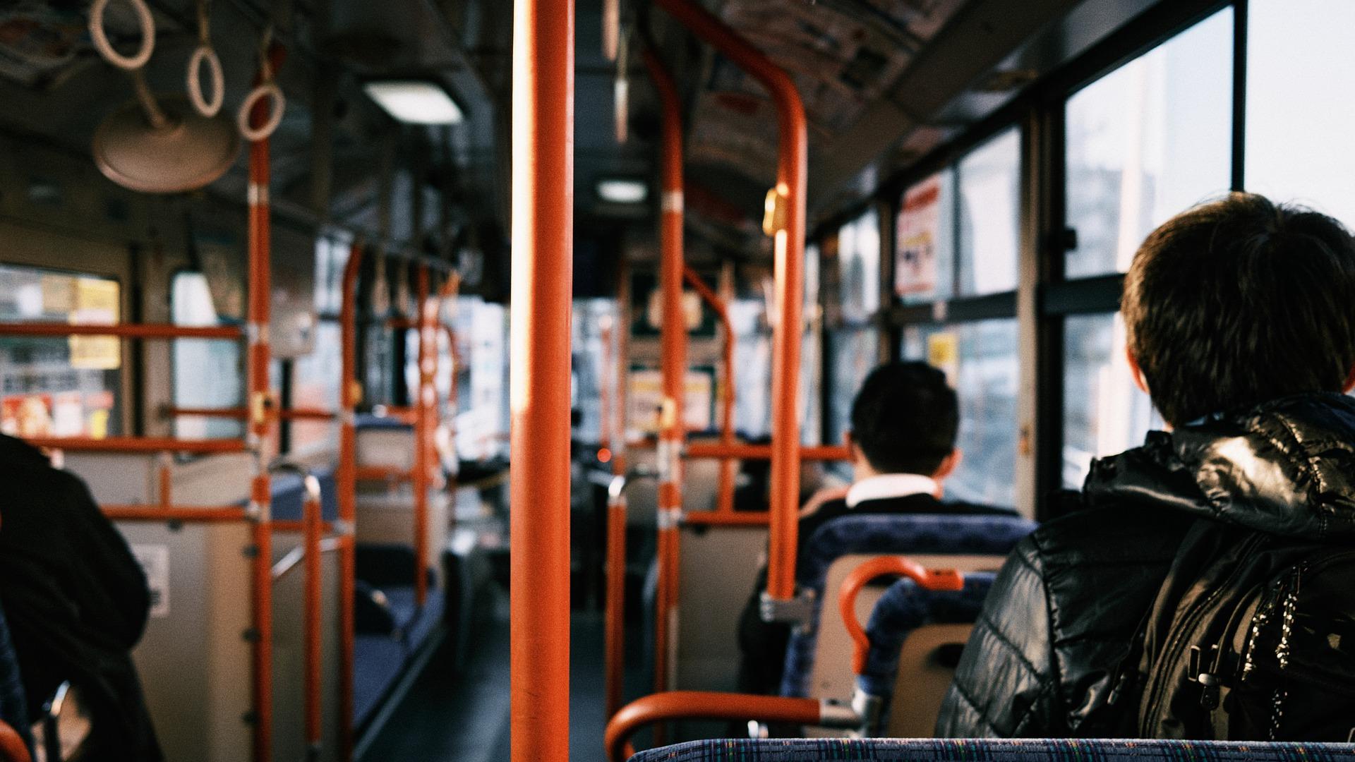 People sitting in a bus - view from the back
