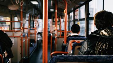 People sitting in a bus - view from the back