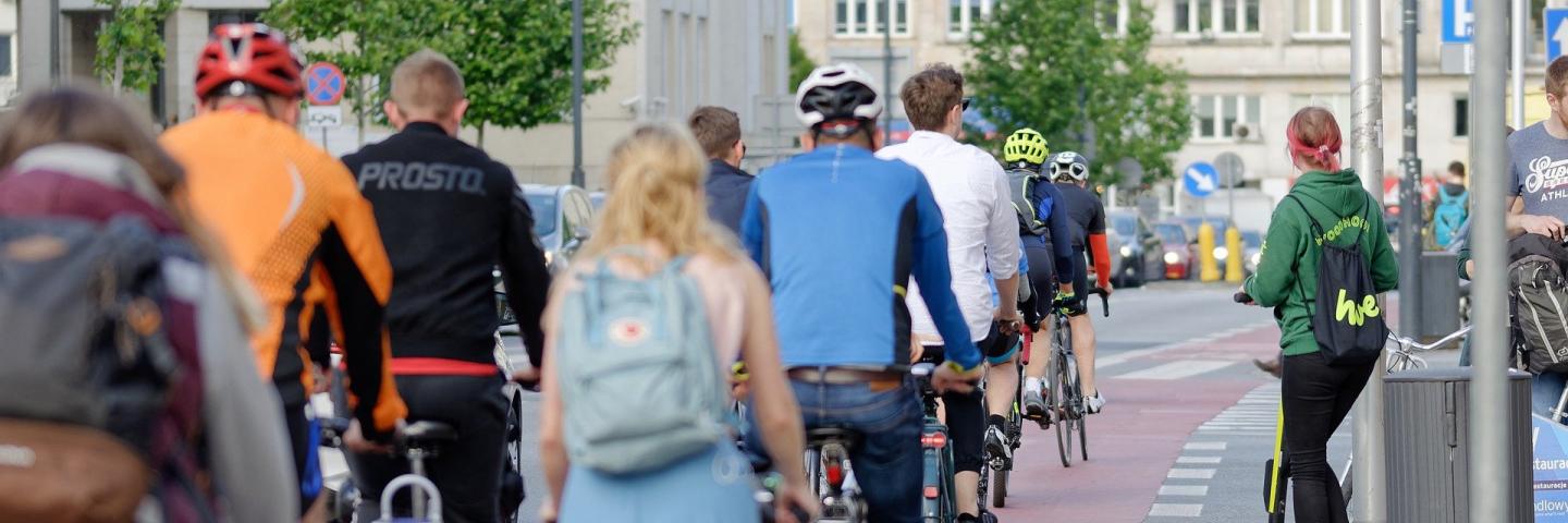 A group of cyclists in the city from behind